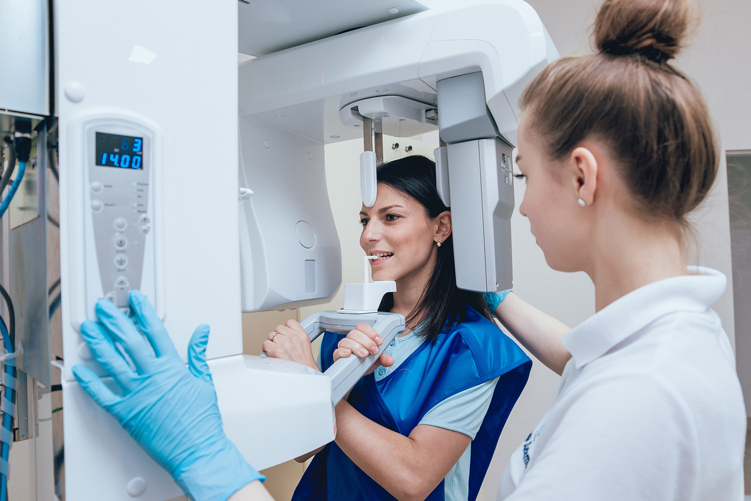 Young woman patient standing in x-ray machine. AdobeStock 171096185
