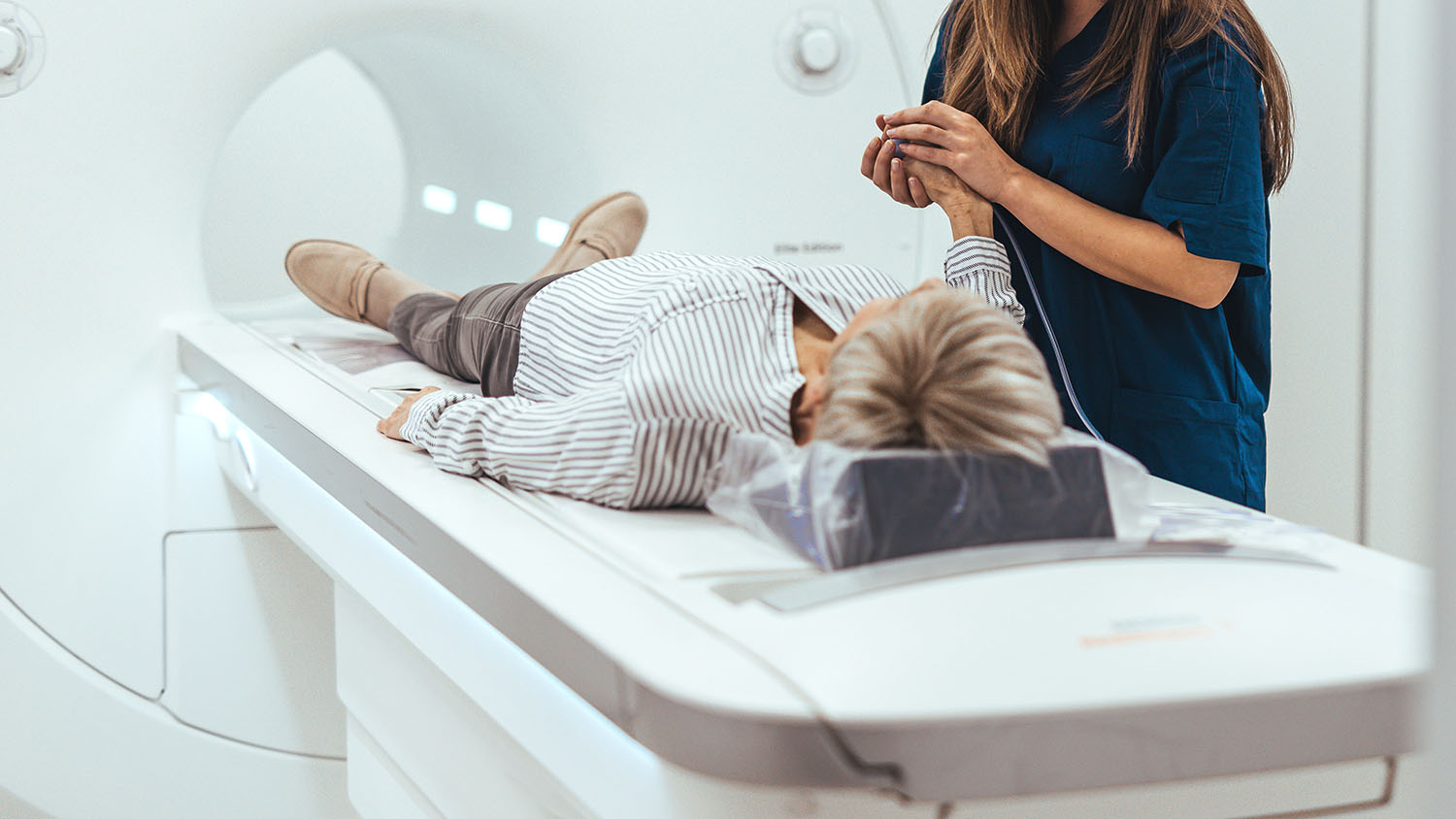 Medical Technician Assists Patient During MRI Scan Procedure in AdobeStock 1570068792